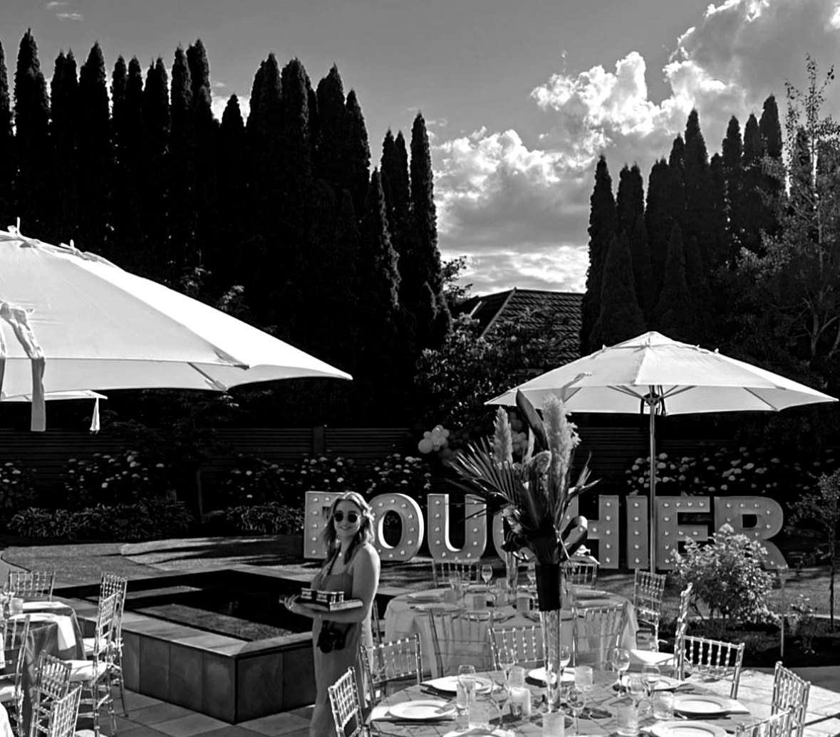 A Bouchier garden party with marquee letters, umbrellas and set tables